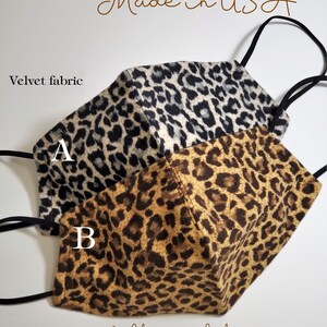 May include: Two leopard print face masks made from velvet fabric. The masks have a nose wire and filter pocket. The masks are labeled A and B. The text "Ready to Ship Made in USA" and "Thank you" are also visible.