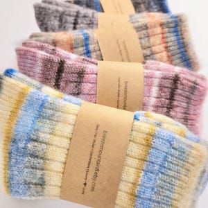May include: A stack of colorful striped socks with a brown paper tag that reads "breezemountain8.etsy.com Cozy Life - Stylish + Comfortable + Luxury...  It's Love."