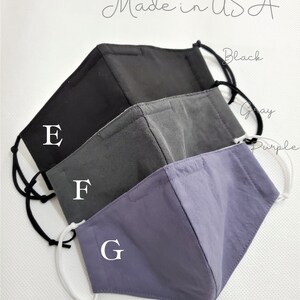 May include: Three reusable face masks in black, gray, and purple with nose wire and filter pocket. The masks are labeled E, F, and G. Ready to ship, made in the USA.