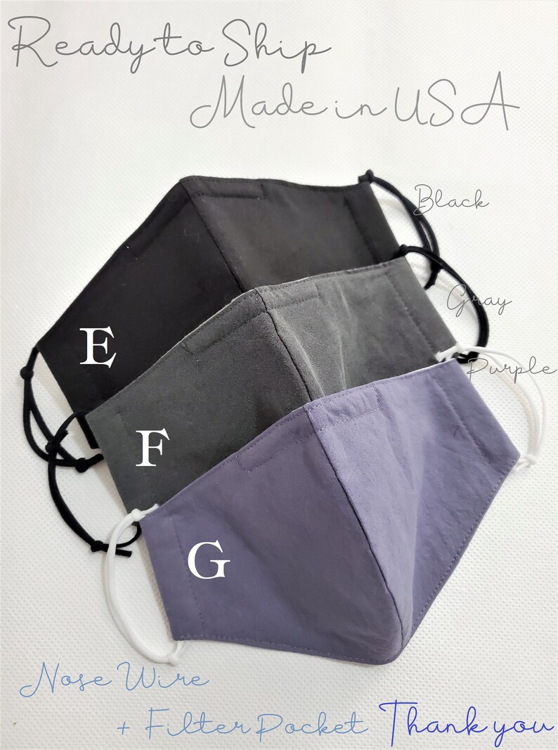 May include: Three reusable face masks in black, gray, and purple with nose wire and filter pocket. The masks are labeled E, F, and G. Ready to ship, made in the USA.