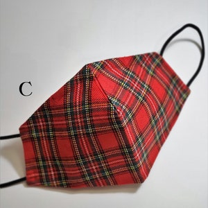 May include: Red and black plaid face mask with black elastic ear loops. The mask is made of a soft, breathable fabric.
