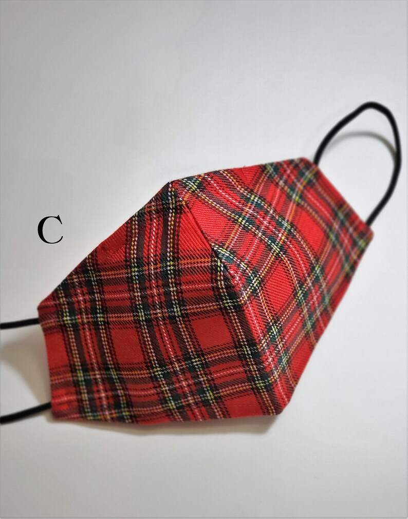 May include: Red and black plaid face mask with black elastic ear loops. The mask is made of a soft, breathable fabric.