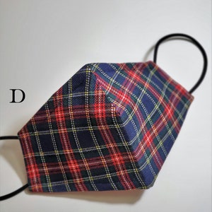 May include: A blue, red, and yellow plaid face mask with black elastic ear loops. The mask is folded in half and the ear loops are visible.