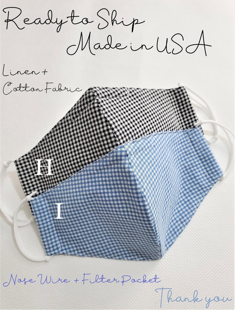 May include: Two face masks made from linen and cotton fabric. The masks are black and white gingham and blue and white gingham. The masks have nose wires and filter pockets. The text "Ready to Ship Made in USA" is at the top of the image. The text "Linen + Cotton Fabric" is below the masks. The text "H" and "I" are on the masks. The text "Nose Wire + Filter Pocket" is below the masks. The text "Thank you" is at the bottom of the image.
