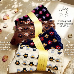 May include: Four pairs of patterned socks in black, brown, navy blue, and cream, each with a floral design. The socks are bundled together with a yellow ribbon. The image includes text that reads "Luxe texture & cool pattern!" and "Feeling that bright sunshine vibe!"