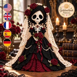 May include: A crocheted doll featuring a skull head and skeleton torso, wearing a black and dark red gown with a cream-colored lace veil. The doll is adorned with crocheted red roses, white pearls, and a dark red pendant, holding a bouquet of red roses.