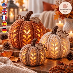 May include: Three crocheted pumpkins in varying sizes and colors, including burnt orange, cream, and light brown. Each pumpkin features a textured leaf-patterned stitch, a dark brown stem, and a small crocheted leaf, with warm light glowing from within.