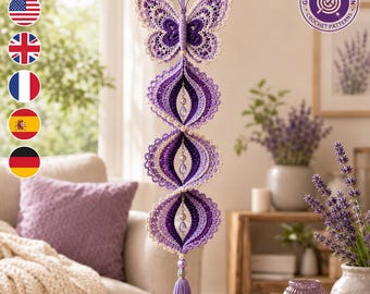 May include: A hanging crochet decoration featuring a purple and cream butterfly at the top, followed by three spiraling, layered circular ornaments in shades of purple and cream, accented with beads and finished with a purple tassel at the bottom.