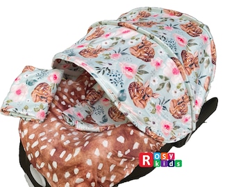 May include: A baby car seat cover with a floral and fawn print. The cover has a hood that can be pulled up to shade the baby. The cover is made of soft, breathable fabric and is machine washable.