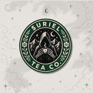 May include: A circular sticker featuring a dark green border with the text SURIEL TEA CO. and floral accents. The center depicts a hooded skeleton figure holding a steaming cup against a backdrop of mountains and stars in black and white.