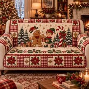 May include: A quilted sofa cover featuring a cream-colored center panel with a gingerbread person and an elf exchanging a gift, surrounded by pine trees and a candy cane. The border displays a red and white plaid pattern with poinsettia motifs.