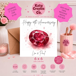 May include: A square greeting card featuring a ruby gemstone illustration with the text Happy 40th Anniversary and the names Leo & Paul. The card measures 148 x 148 mm and is presented with a kraft envelope, a pink pen holder, and pink flowers.