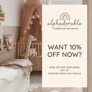 May include: A nursery room with a crib, a giraffe stuffed animal, and a canopy over the crib. The text on the image reads "alphadorable NURSERY ART AND DECOR WANT 10% OFF NOW? SIGN UP FOR OUR EMAIL LIST AT: alphadorable.com/signup"