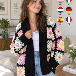 May include: A long-sleeved cardigan featuring a black ribbed trim and a pattern of multi-colored granny squares in shades of pink, yellow, lavender, and light blue. The garment is worn over a white top and blue denim jeans.