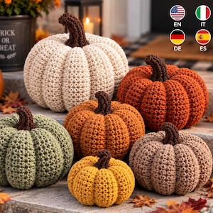 May include: A collection of six handmade crochet pumpkins in various sizes and colours, including cream, orange, sage green, mustard yellow, and tan. Each pumpkin features a dark brown crocheted stem and a textured, ribbed yarn surface.