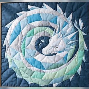 May include: A square quilted wall hanging featuring a pieced fabric design of a coiled dragon. The dragon is rendered in shades of white, light blue, mint green, and dark blue, with geometric stitching patterns throughout the fabric surface.