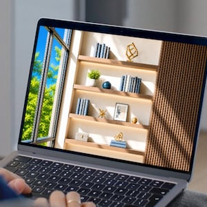May include: A silver laptop displaying an image of a modern interior with wooden shelves. The shelves are filled with blue books, small potted plants, gold geometric sculptures, and a framed picture, all illuminated by natural light from a window.