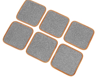 May include: Set of six gray fabric coasters with a brown wood frame. The coasters are arranged in a staggered pattern.