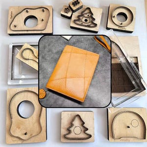 May include: A rectangular mustard yellow leather wallet with a textured surface and stitched panel details, surrounded by various wooden cutting dies featuring metal blades in shapes like circles, trees, and abstract forms on a gray surface.