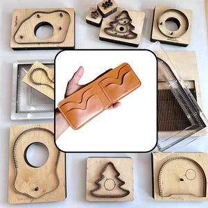 May include: A tan leather bifold wallet featuring multiple card slots with wavy edges and visible stitching, surrounded by various wooden cutting dies with metal blades for leather crafting, including shapes like trees and circles.
