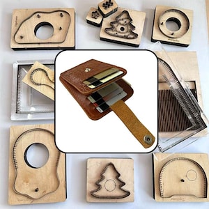 May include: A brown textured leather card holder with a snap button closure and a pull-tab strap, containing multiple credit cards. The wallet is surrounded by various wooden and metal die-cutting molds used for leather crafting and shape cutting.
