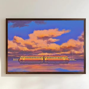 May include: A framed horizontal art print depicting a yellow and red train traveling across a calm body of water. The scene features a vibrant sunset sky filled with orange and pink clouds, with the train reflected clearly in the water below.
