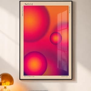 Könnte beinhalten: Ein rechteckiger Wandkunstdruck in einem schwarzen Rahmen mit einem Farbverlaufshintergrund in Orange, Pink und Lila sowie drei leuchtenden kreisförmigen Kugeln. Der Text umfasst NO.01, TEMPERATURE OF COLORS, COLOR IN MOTION, WHERE LIGHT MEETS COLOR und ESTD 2026.