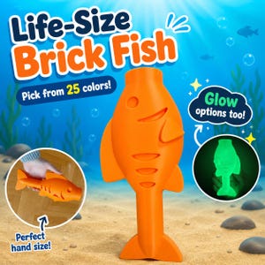 May include: An orange fish-shaped toy with a smooth surface, featuring a circular eye, a curved mouth, and gill slits. The image includes text stating Life-Size Brick Fish, Pick from 25 colors, Glow options too, and Perfect hand size.
