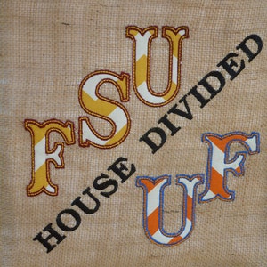 May include: A burlap fabric bag with the text "House Divided" in black letters. The letters "FSU" are embroidered in yellow and orange stripes. The letters "UF" are embroidered in orange and blue stripes.