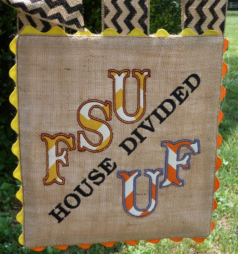 May include: A burlap banner with the text "House Divided" and the letters FSU and UF in orange, white, and blue stripes.