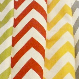 May include: A collection of fabric swatches with a chevron pattern in various colors, including teal, orange, yellow, red, gray, and black.