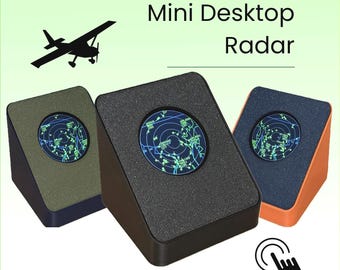 May include: Three wedge-shaped Mini Desktop Radar devices with circular screens displaying green digital maps. The units are black, olive green, and orange. A black silhouette of an airplane is shown, and the text reads Mini Desktop Radar and Touchscreen!