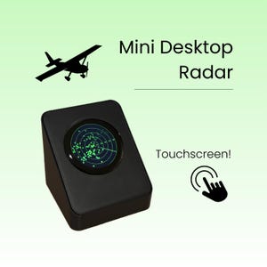 May include: A black desktop device featuring a circular screen displaying a green radar interface with scattered dots. The text reads Mini Desktop Radar and Touchscreen! with a black aeroplane silhouette and a hand icon indicating touch interaction.