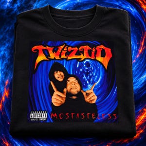 May include: A black t-shirt featuring a graphic print of two hooded figures with white eyes against a blue swirling vortex background. The text TWIZTID appears in orange and yellow at the top, with MOSTASTELESS in red and a Parental Advisory label.