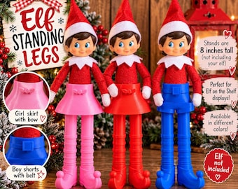May include: Three elf dolls wearing red hats and jackets with white collars. Each elf stands on a plastic base with legs: one pink skirt with a bow, one red skirt, and one blue pair of shorts with a belt. Text reads: Elf Standing Legs, 8 inches tall.