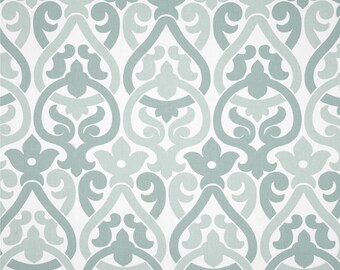 May include: A white fabric with a repeating pattern of teal blue damask designs. The fabric has a subtle texture.