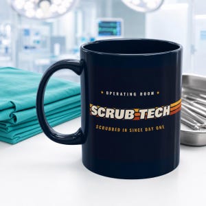 May include: A dark blue ceramic mug featuring the text "OPERATING ROOM" with two stars, the words "SCRUB TECH" in large white letters, and the phrase "SCRUBBED IN SINCE DAY ONE" below, accented by horizontal orange and yellow stripes.