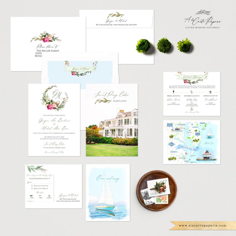 May include: A collection of custom wedding stationery, including invitations, RSVP cards, and envelopes. The designs feature floral accents, watercolor illustrations of a house and a sailboat, and a map. The color palette includes white, green, pink, and blue.