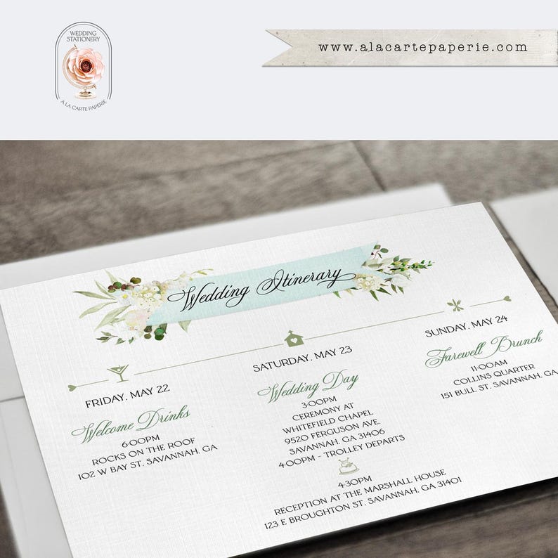 May include: A white wedding itinerary card featuring a light blue banner with the text Wedding Itinerary, decorated with floral illustrations. The card lists events for Friday, Saturday, and Sunday in Savannah, GA, with small icons for each event.