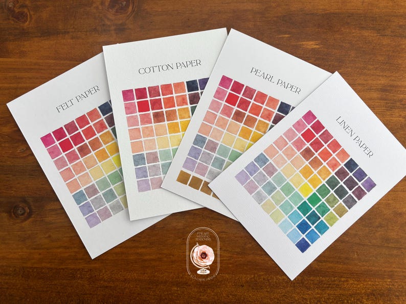 May include: Four white rectangular paper sample sheets labeled Felt Paper, Cotton Paper, Pearl Paper, and Linen Paper. Each sheet features a grid of small, multi-colored watercolor squares in various shades of red, orange, yellow, green, blue, and purple.