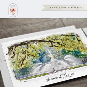May include: A rectangular greeting card featuring a watercolor illustration of a fountain in Savannah, Georgia, surrounded by green trees with hanging moss. The text Savannah, Georgia is printed in black script at the bottom of the card.
