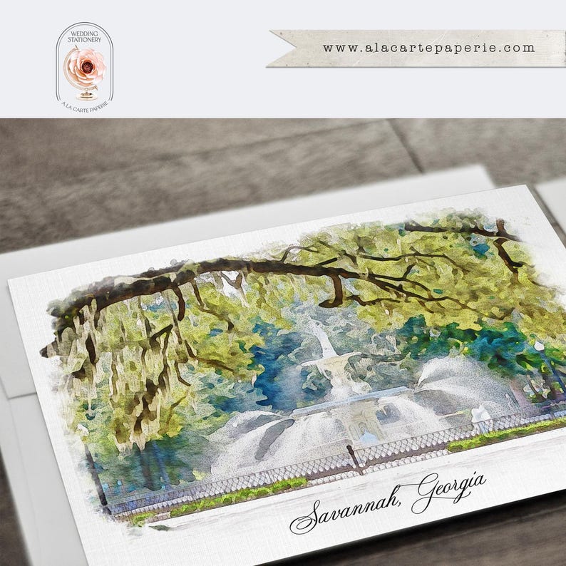 May include: A rectangular greeting card featuring a watercolor illustration of a fountain in Savannah, Georgia, surrounded by green trees with hanging moss. The text Savannah, Georgia is printed in black script at the bottom of the card.