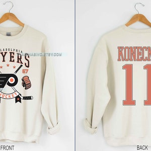 Philadelphia Flyers Travis Konecny Hockey Paper T-shirt,Sweater, Hoodie,  And Long Sleeved, Ladies, Tank Top