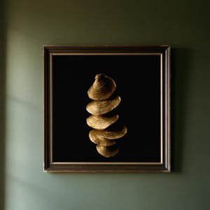May include: A square framed wall art piece featuring a vertical arrangement of five gold-colored, textured, shelf-like fungi against a solid black background. The dark brown frame has a thin gold inner border, presenting a high-contrast display.