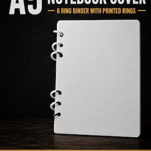 May include: A white A5 notebook cover featuring a 6-ring binder mechanism with printed rings. The text A5 NOTEBOOK COVER - 6 RING BINDER WITH PRINTED RINGS is displayed at the top, and 3MF | INSTANT DOWNLOAD is printed at the bottom.