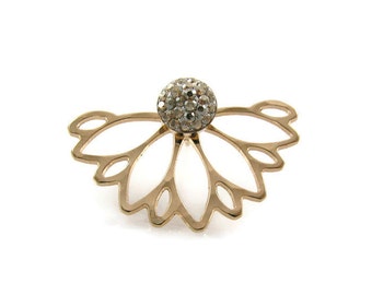 May include: Gold-tone ear cuff with a delicate floral design and a clear crystal center.
