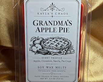 May include: A clear plastic clamshell package containing red soy wax melts. The label reads: Kayla's Chaos, Grandma's Apple Pie, Scent Profile: Apples, Cinnamon, Vanilla, Pie Crust, Soy Wax Melts, Phthalate Free Scents, Net Wt. 2.5 oz (70.9 g).