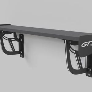 May include: A matte black wall-mounted shelf designed to resemble a car spoiler. The shelf features two intricate, curved support brackets and a side end plate clearly displaying the white text GT3RS. The structure is mounted horizontally.