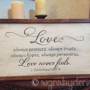 Ready-to-Ship Love always...love never fails. 1 Corinthians 13:7-8 Scripture Sign with wood frame - 22" x 12" SignsbyDenise