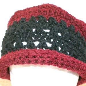 May include: A burgundy crocheted hat with a black crocheted band.